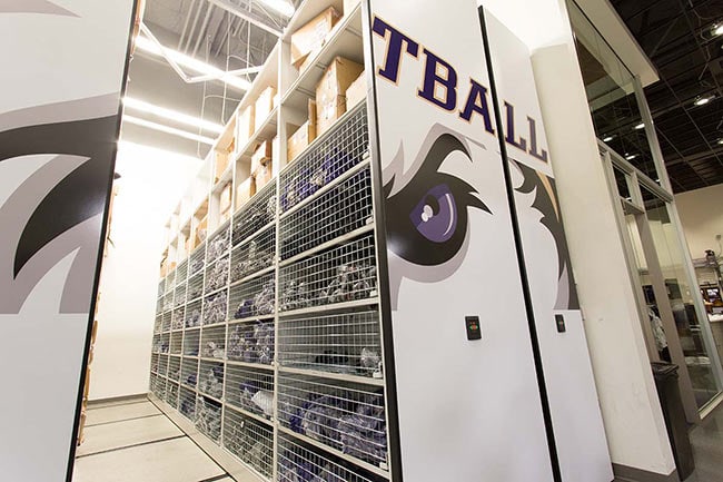Athletic Equipment Stored in Wire Baskets on Powered Compact Mobile Shelving